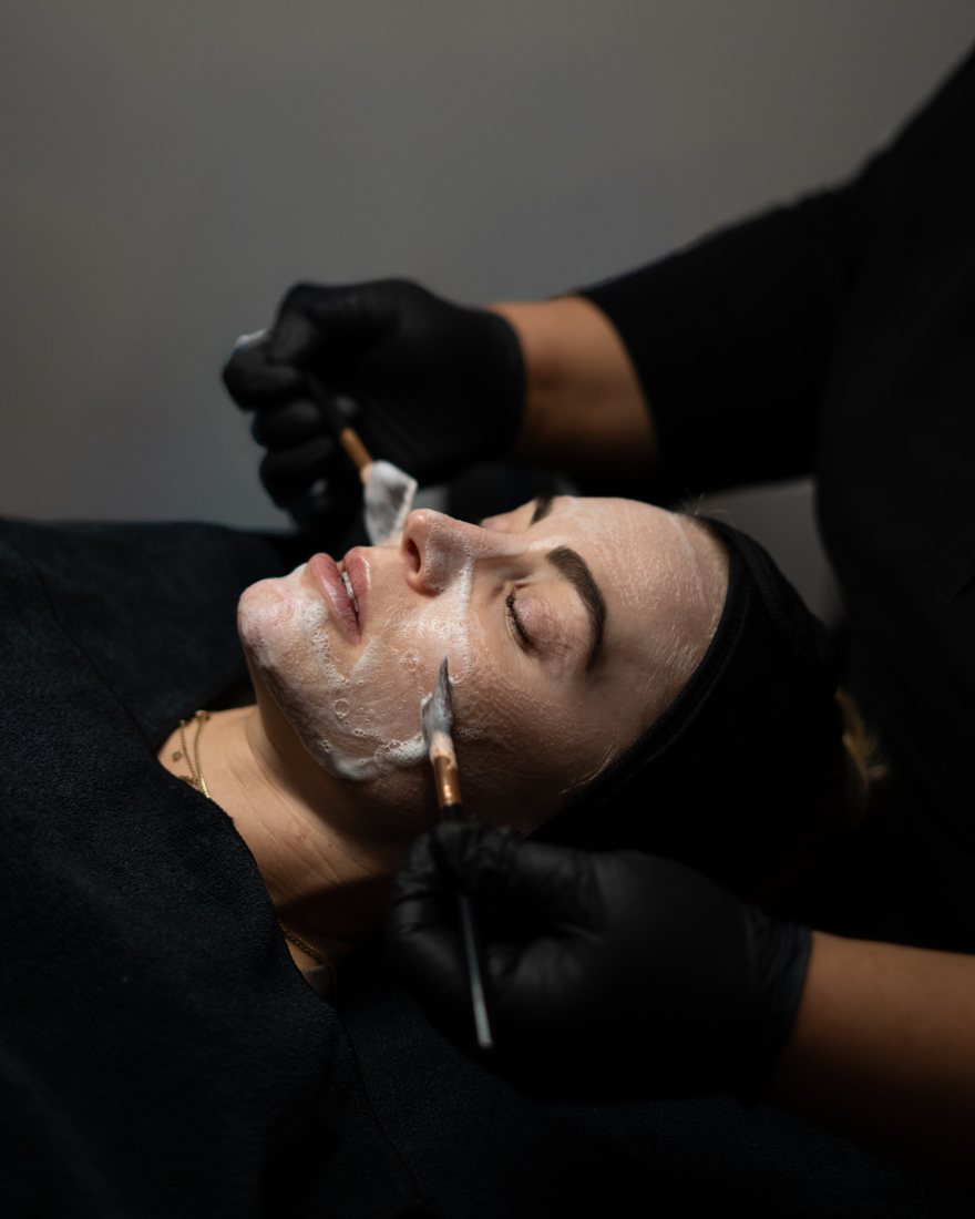 Cleansing facial with brushes and gloved hands