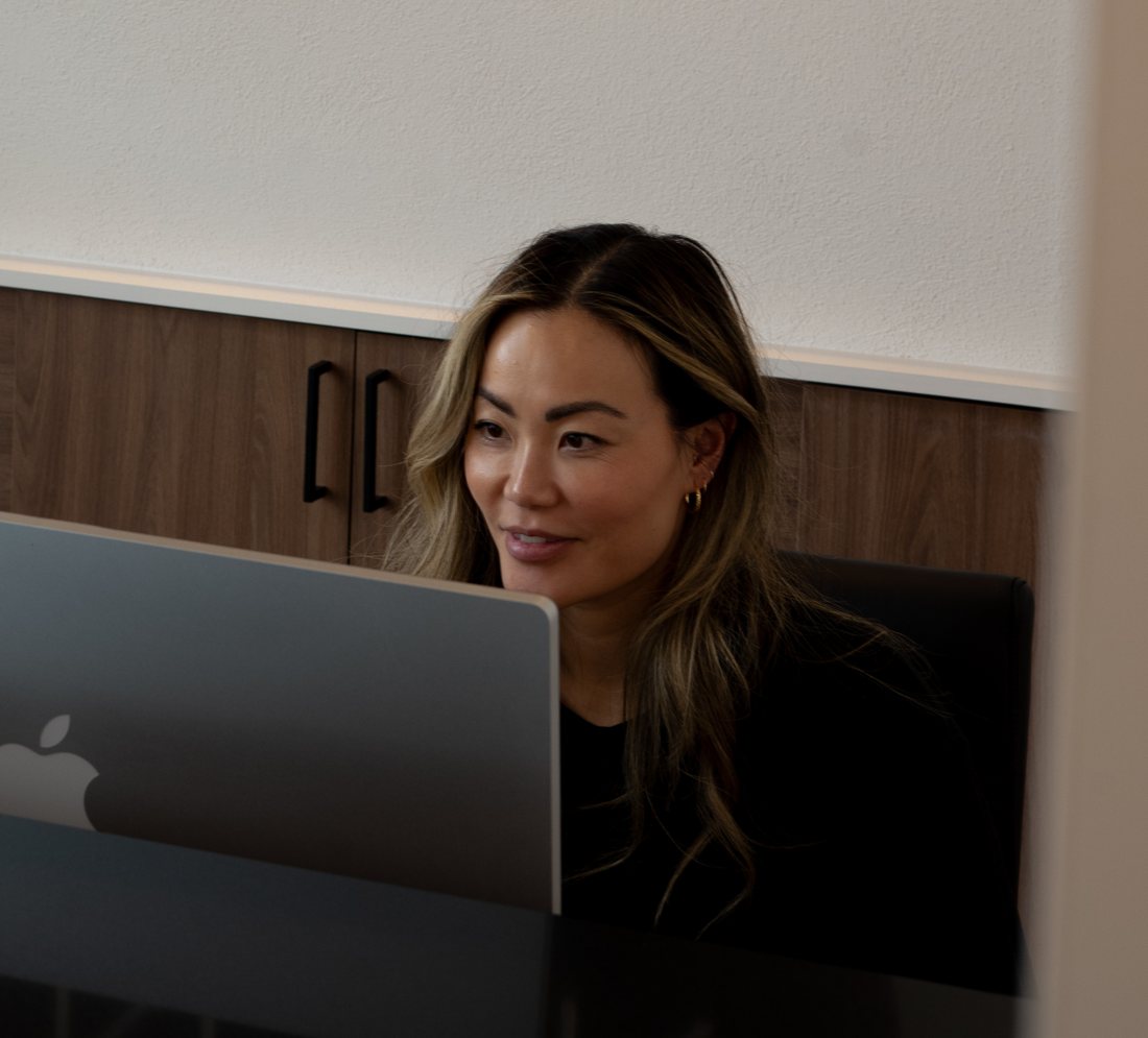 Front desk team member smiling at her screen